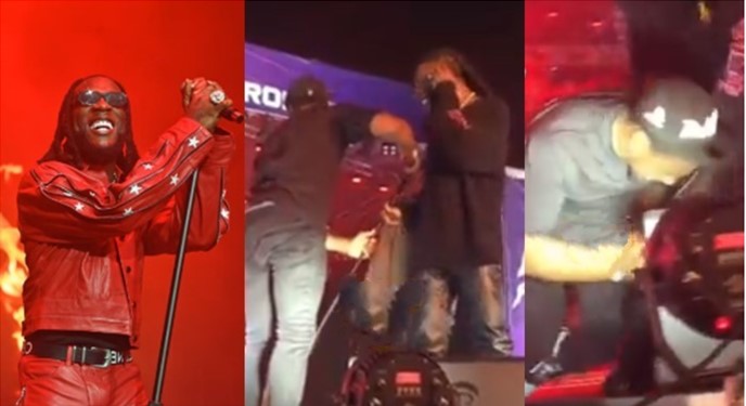 Burna Boy saves his assistant from having accident on stage during concert (Video) - burna boy assistant fall 1