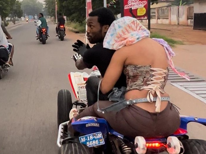 Reactions as lady hides her face while riding bike with Meek Mill in Ghana (Video) - meek mill bike ghana